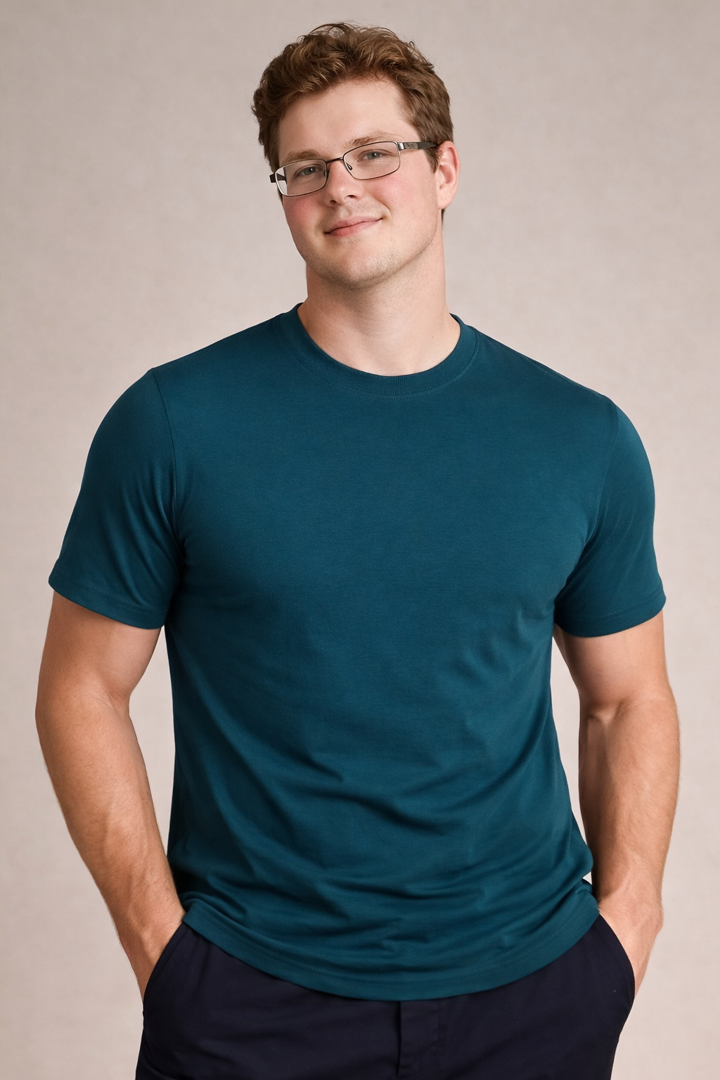 Man wearing a teal t-shirt against a plain background