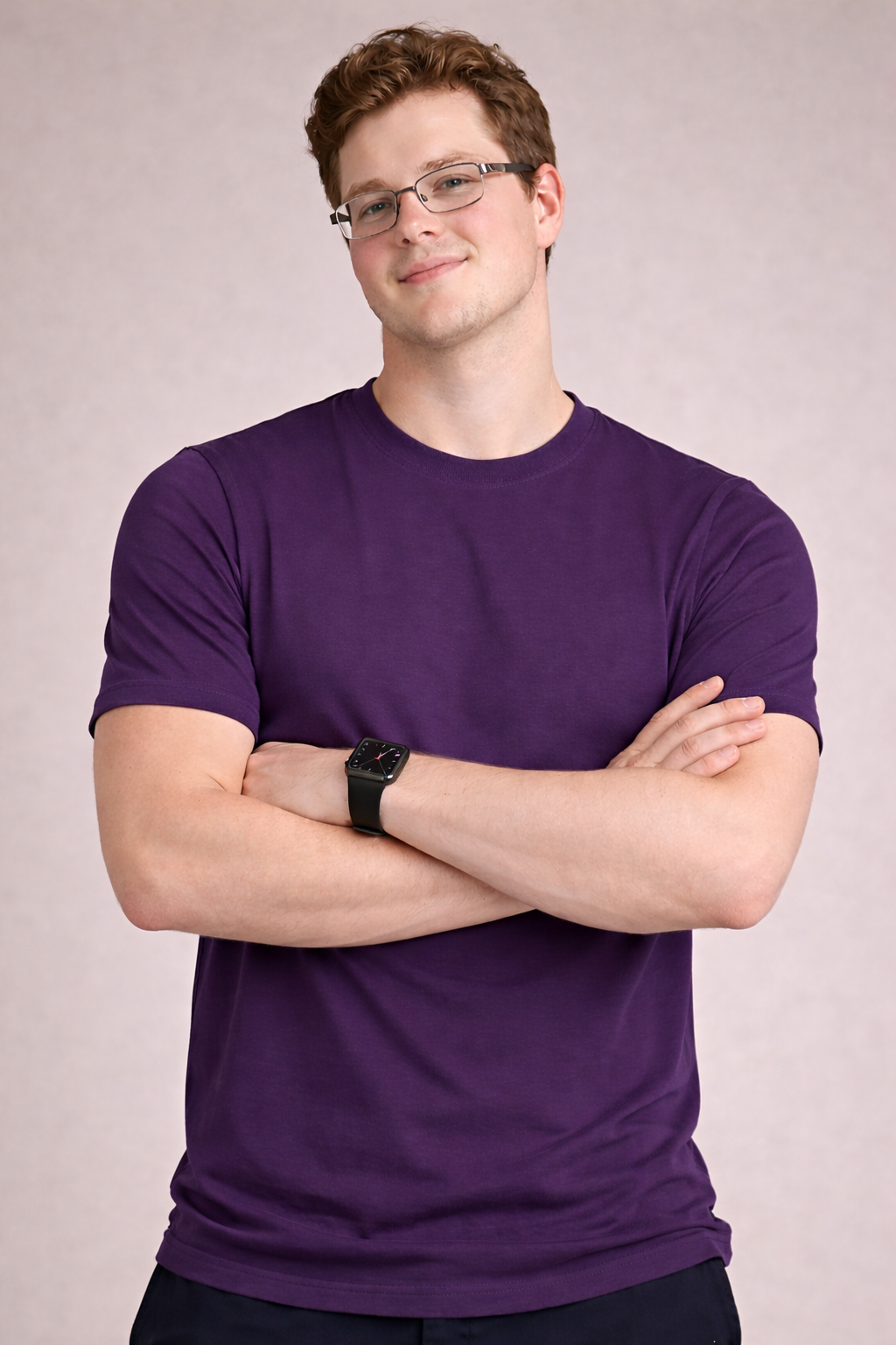 Man wearing a purple t-shirt with arms crossed against a plain background