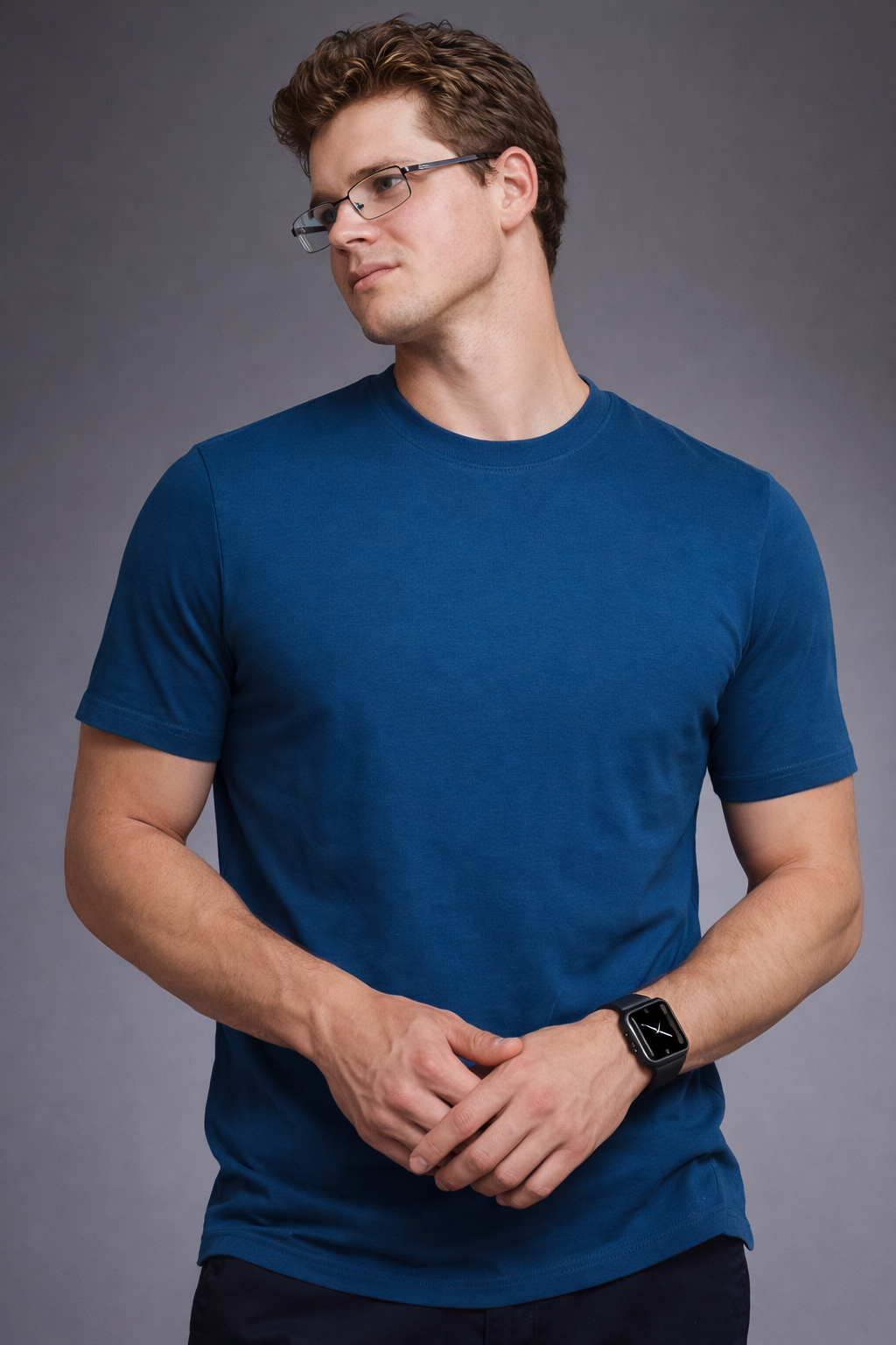 Man wearing a blue t-shirt against a gray background