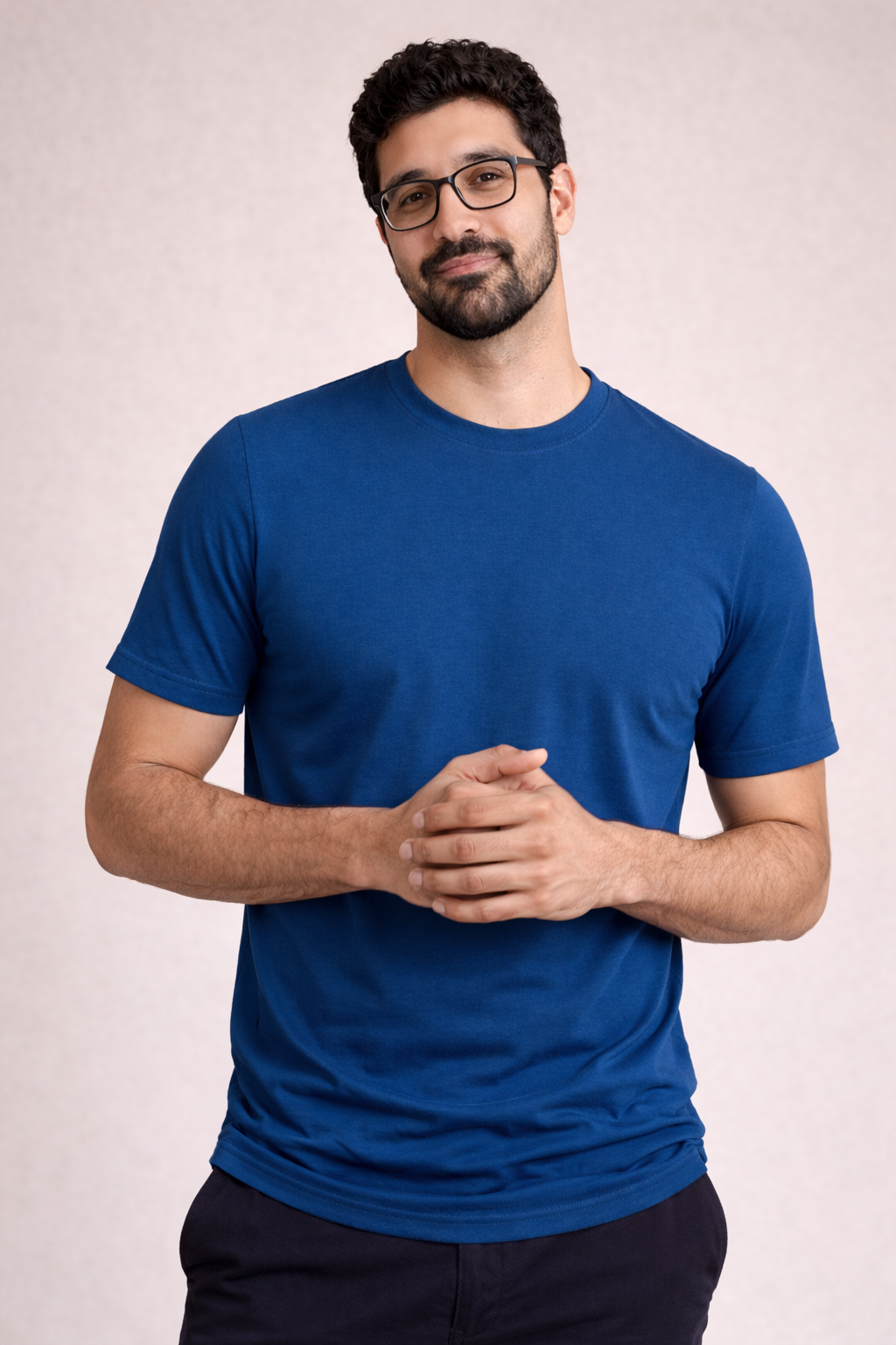 Man wearing a blue t-shirt against a plain background