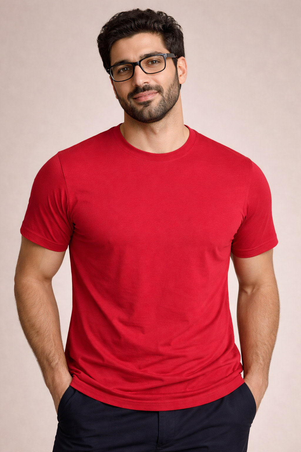Man wearing a red t-shirt and glasses against a beige background