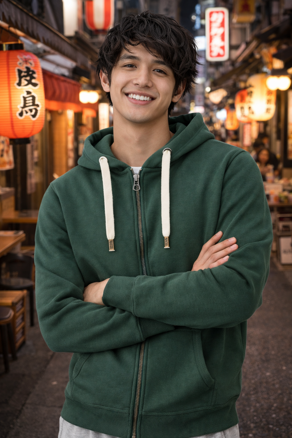 Person wearing a green hoodie in a street setting with traditional lanterns and signs.