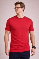 Man wearing a red t-shirt against a plain background